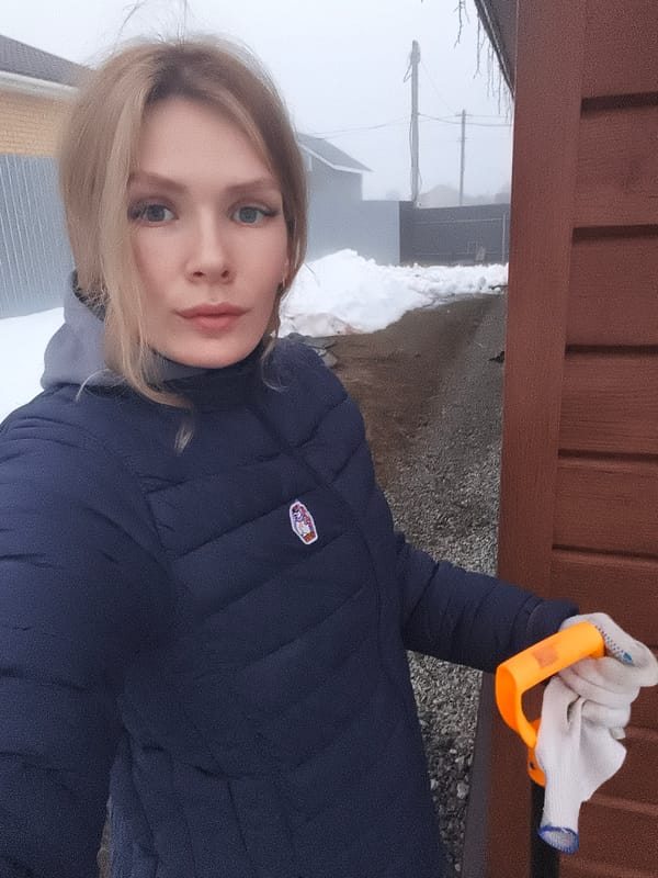 Woman photographed holding work glove in Russian village