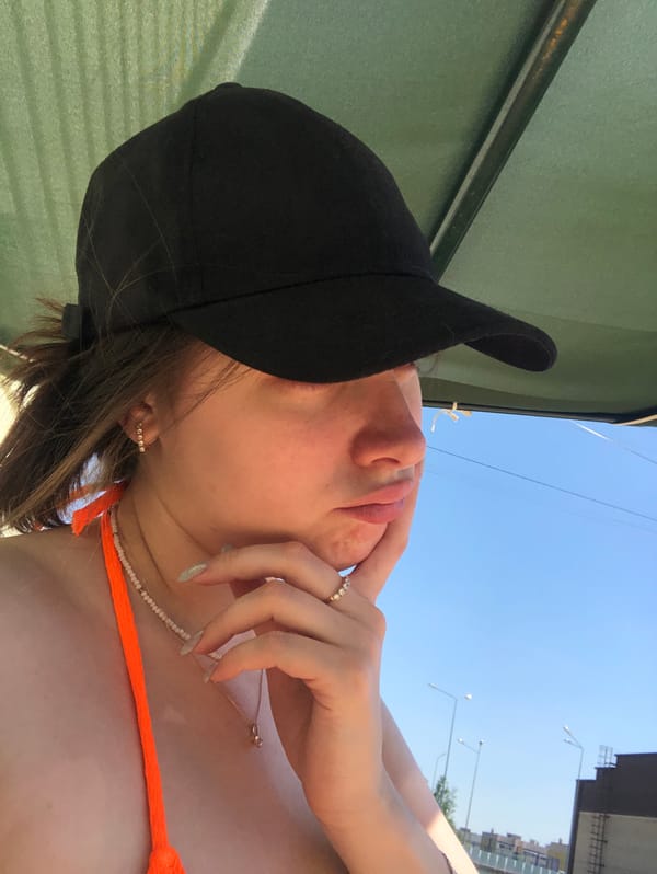 Woman in orange bikini photographed outdoors in Noviy, Russia