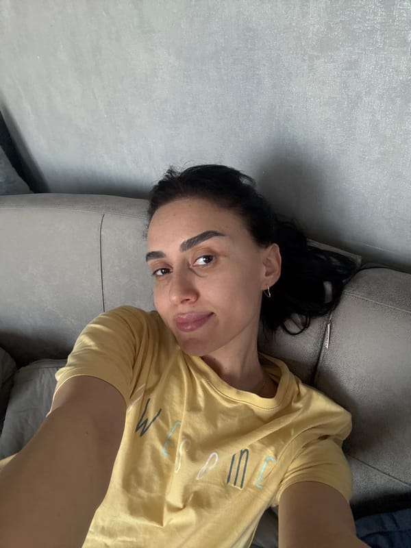 Woman takes selfie on sofa in Tbilisi