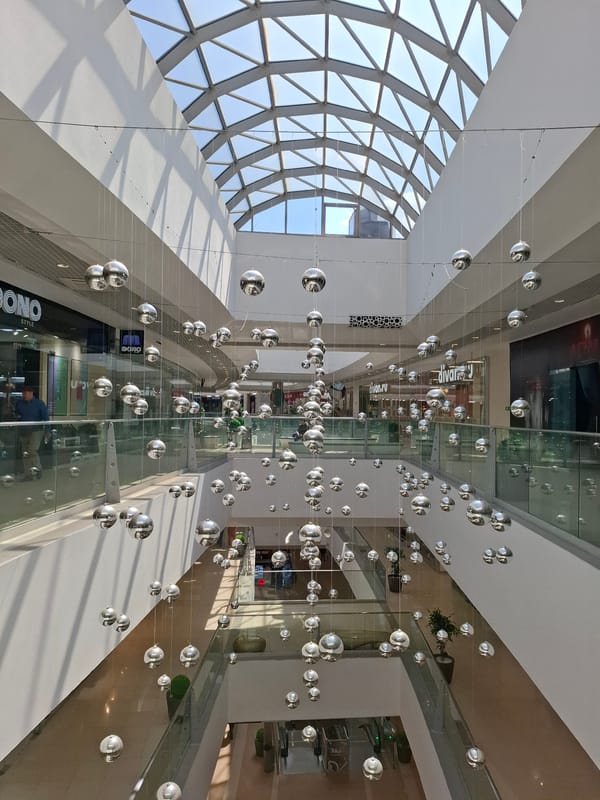 Early morning view captures multi-level mall's arched glass ceiling