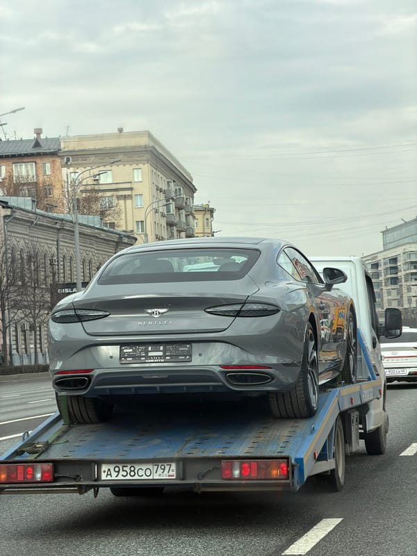 Bentley Continental GT transported on flatbed truck in Moscow