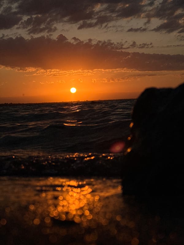 Sunset over a Kokshetau lake, orange light on the water