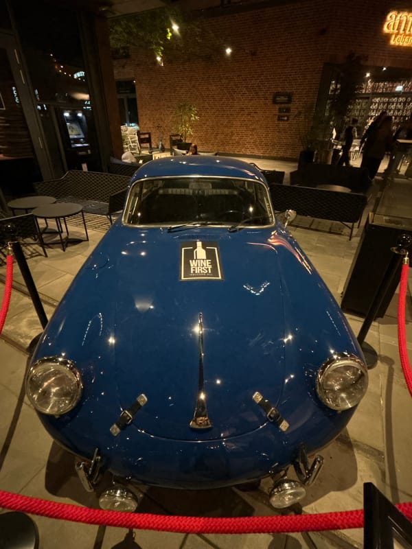 Vintage car display outside Warsaw restaurant draws evening attention