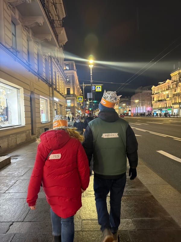 Two people in foil hats walk Saint Petersburg streets