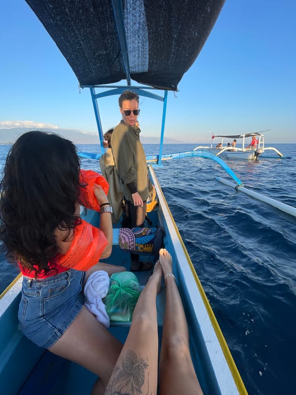 Boats and people on calm Indonesian waters on a clear day