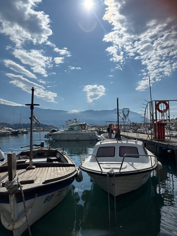 Woman takes selfies at Budva marina on sunny morning