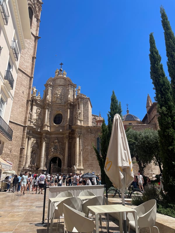 Tourists gather at Valencia Cathedral for ice cream and street performances