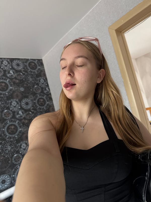 Quick bedroom selfie session with pink sunglasses and black top