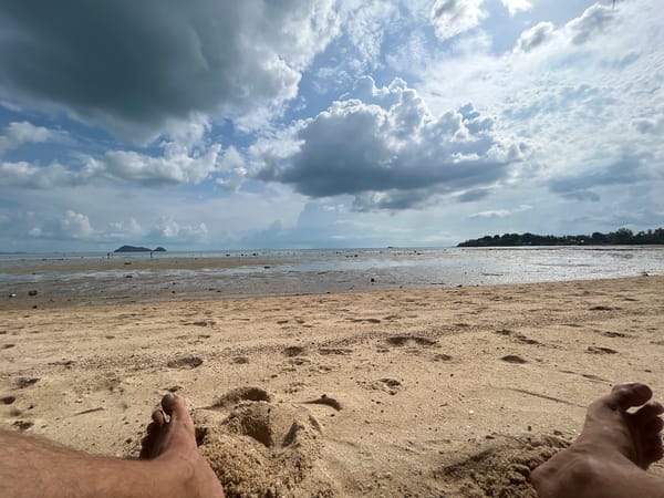 Low tide reveals expansive mudflats at Thai beach