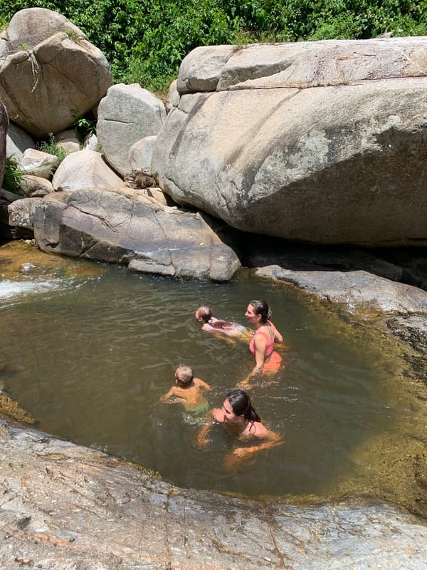 Families enjoy morning swim at natural rock pools in Ko Samui