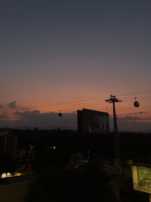 Mexico City nighttime skyline captured with cable car system visible