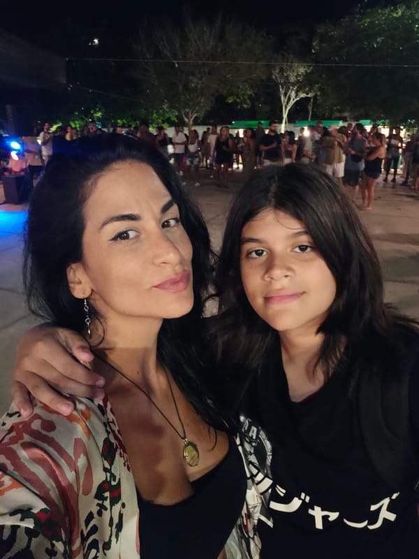 Live band performs outdoor nighttime concert with dancing audience