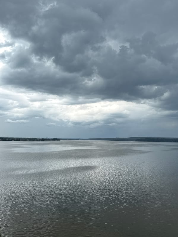 Storm clouds gather over a Votkinsk waterfront on a June morning
