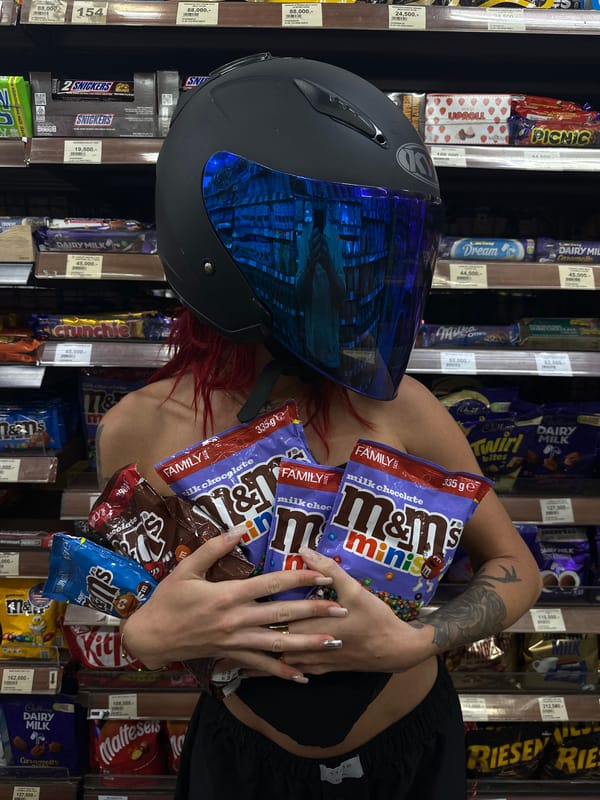 Helmeted motorcyclist goes candy shopping in North Kuta supermarket