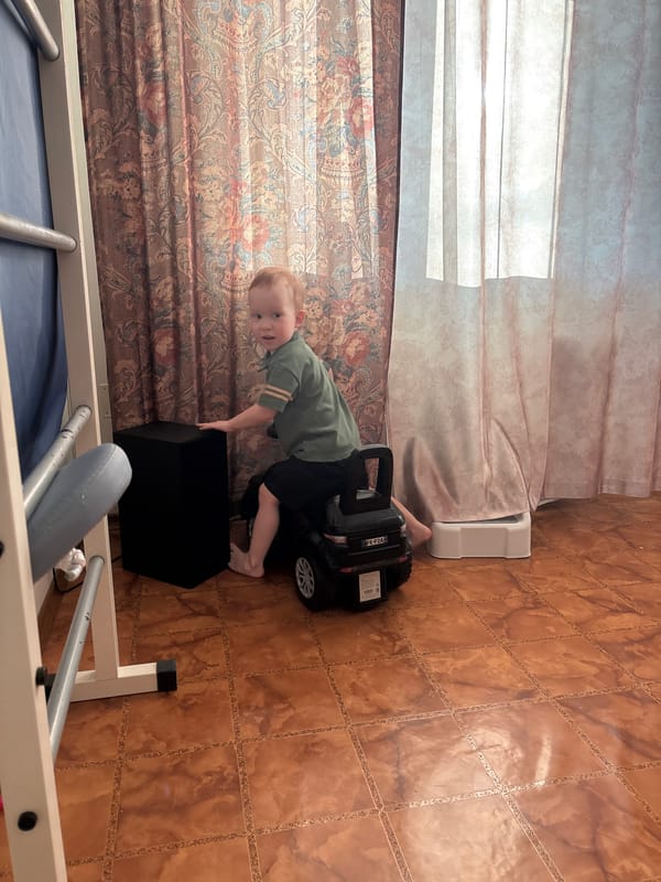 Toddler plays with toys indoors in Ферма, Russia