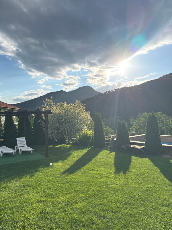 Afternoon scenes documented in Bulgarian village with pool, mountains