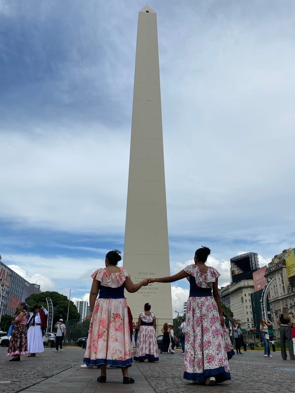 Women in traditional dress gather at Buenos Aires Obelisco