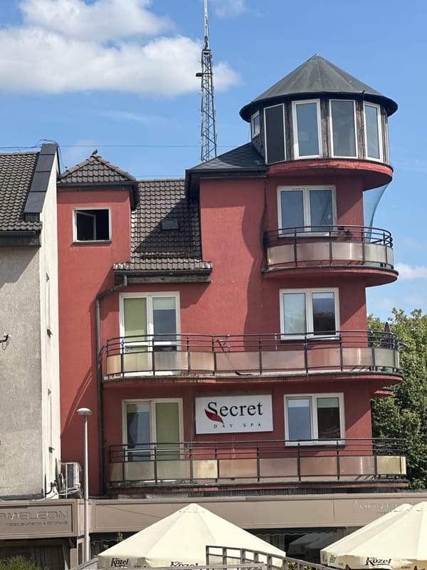 Street-level look at Pruszcz Gdański's architecture and summer blooms