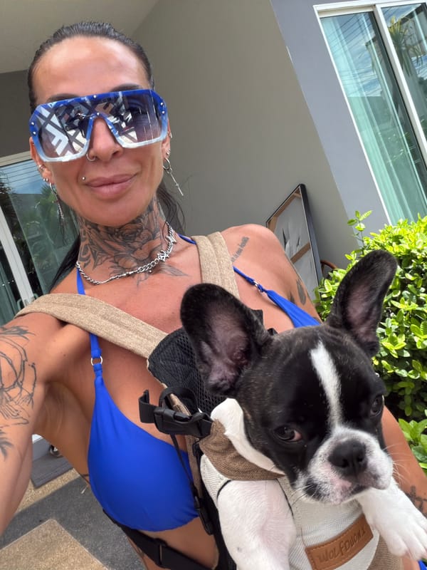 Tattooed traveler poses with French bulldog in Thai summer style