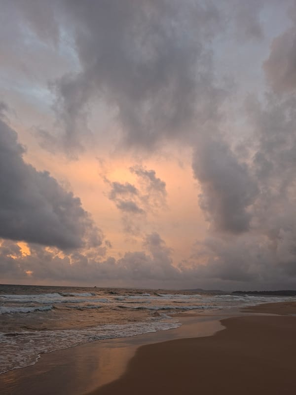 Phú Quốc beach at dusk, clouds breaking into a vivid sunset
