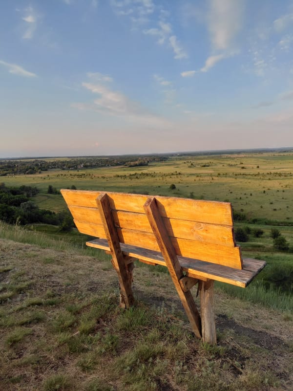 Golden hour across open fields and rolling rural hills