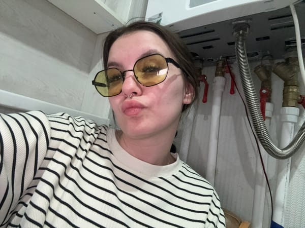 Person poses upside down near plumbing in Russian building