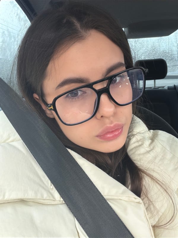 Woman's quiet moment captured in vehicle during rainy weather