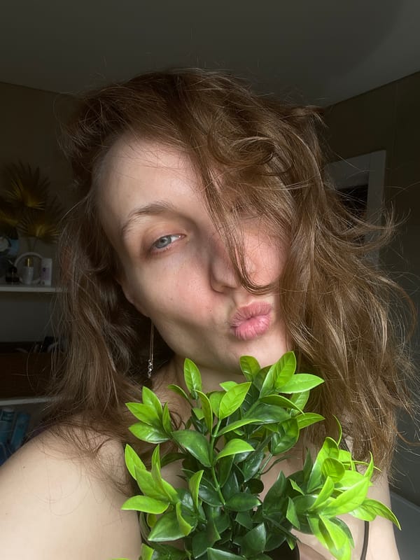 Woman poses with plants in Podshivalovo portrait session