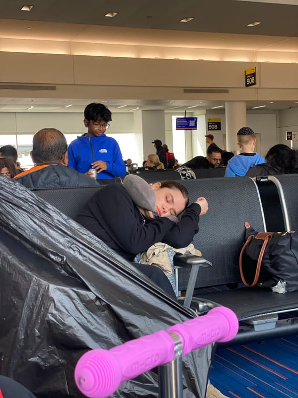 Passengers wait in NYC airport terminal during afternoon hours