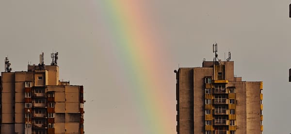 Rainbow appears between apartment buildings in Burgas, Bulgaria