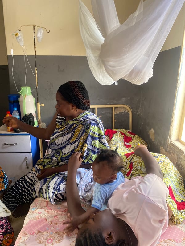 Women care for baby in Nigerian medical facility