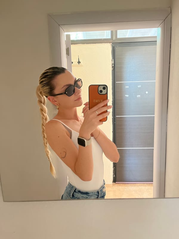 Woman takes mirror selfies with orange KIMI phone