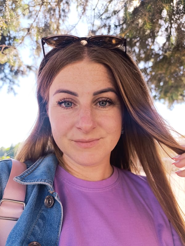 Selfies and scenery at a sunny tiled plaza with pine trees