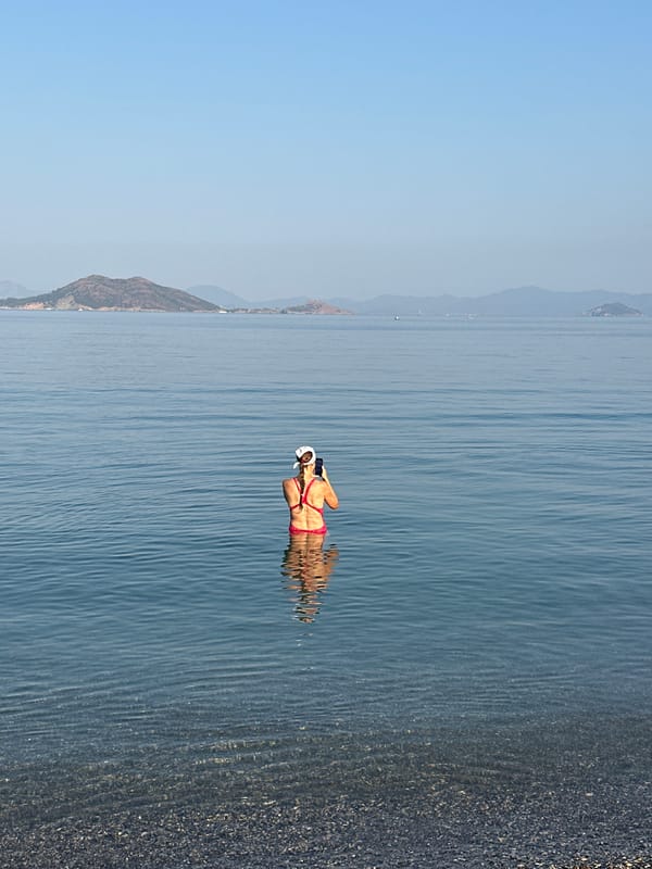 Calm morning at a Fethiye pebble beach and bay
