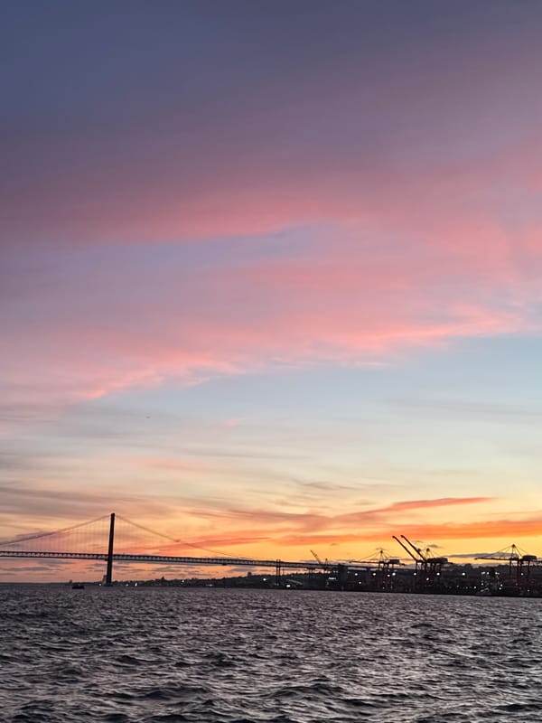 Sunset colors illuminate 25 de Abril Bridge in Portugal