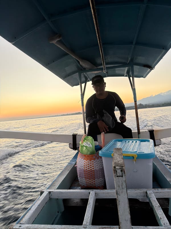 Small boat on choppy Balinese waters at sunset