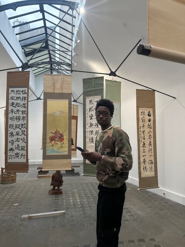 Visitors explore Asian art exhibition in Paris gallery