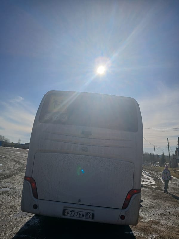 White bus and pedestrians documented on pavement surfaces