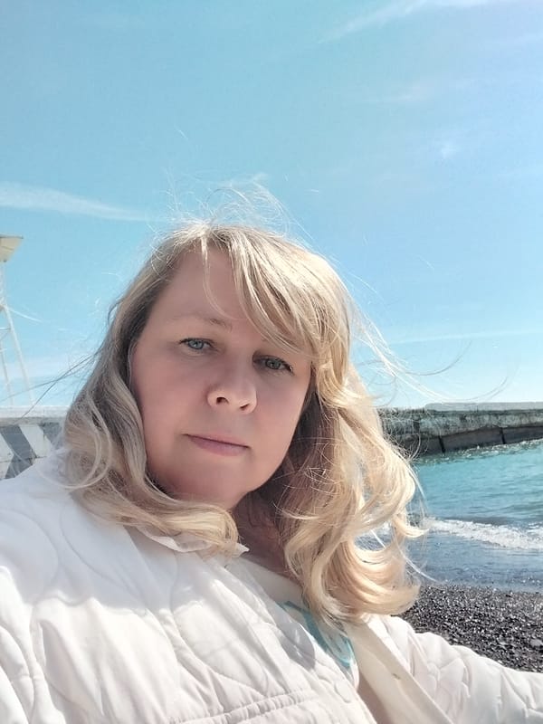 Blonde woman photographed at Sochi coastal locations during sunny morning