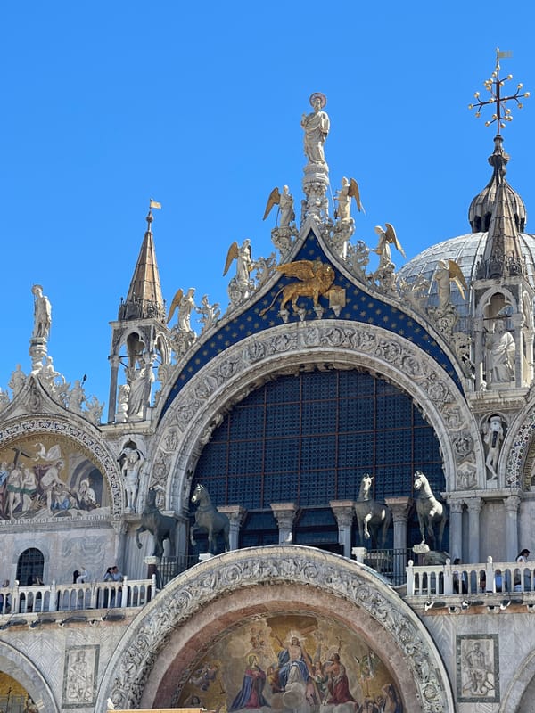 Tourist photographs St. Mark's Square landmarks on sunny morning