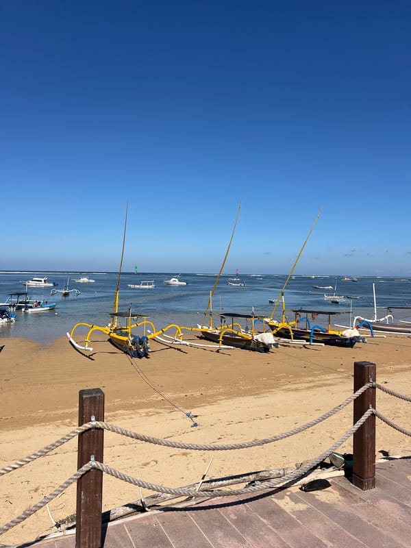 Sanur Beach at sunrise, jukung boats and Agung on the horizon