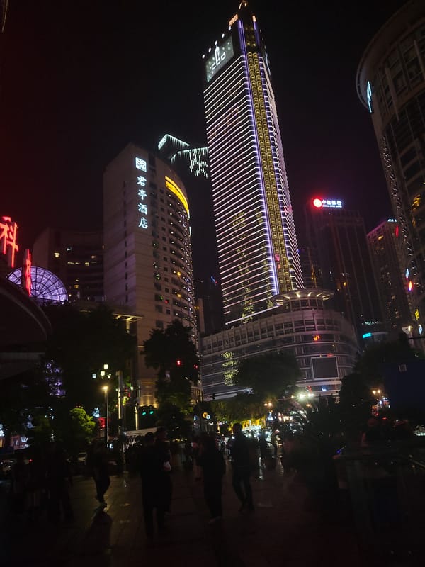 Evening street life documented in Chongqing's illuminated Yuzhong District