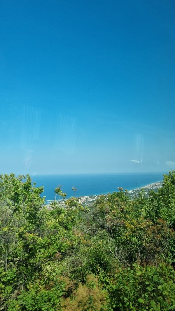 Hillside views over a Greek coastal town on a clear summer day