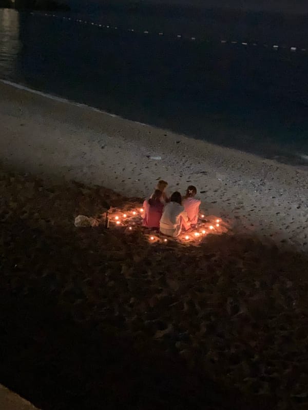 Three people kneel by candles in Montenegro town center