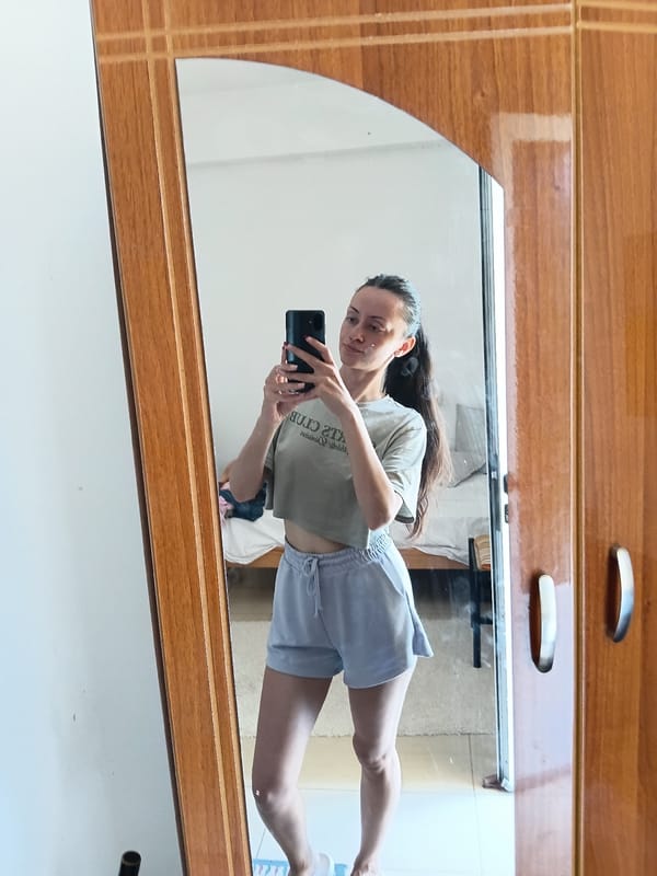 Woman takes mirror selfies in Vlora, Albania apartment