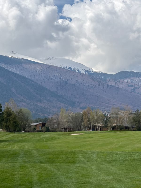Mountain golf course documented under cloudy skies in Razlog
