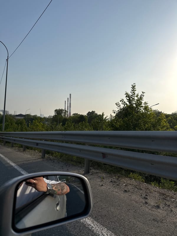 Vehicle passenger documents roadside industrial landscape near Vladivostok