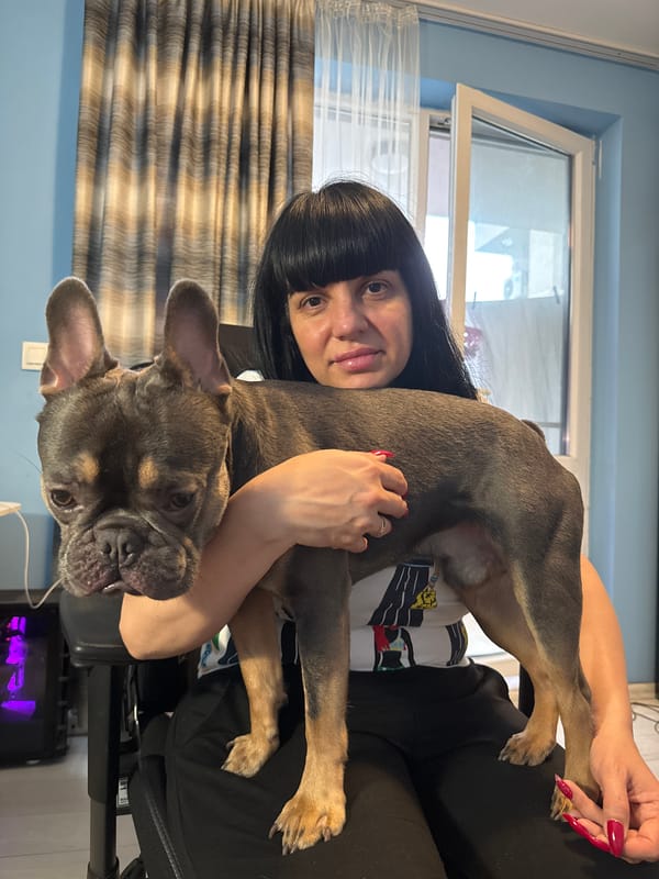Woman and French Bulldog puppy share quiet moment in Burgas