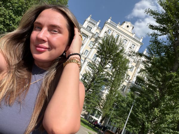 Person photographed amid Shcherbinka cityscape with distinctive tower