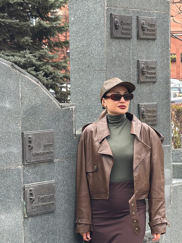 Woman visits memorial monument in rainy Krasnoyarsk morning